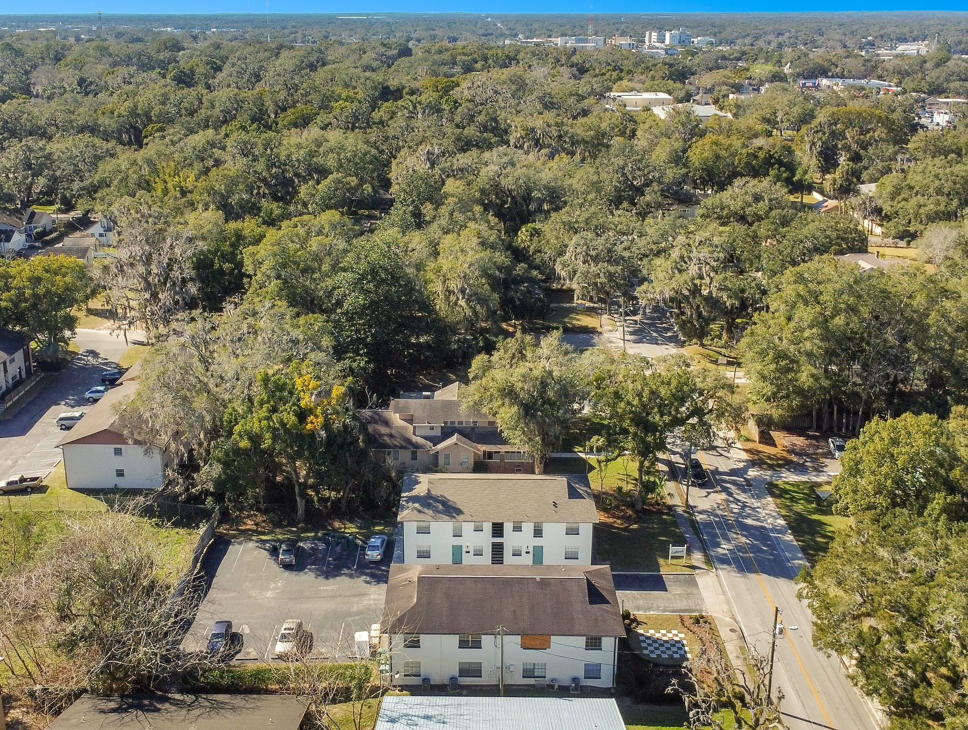 A man and a woman are walking down the street holding hands.