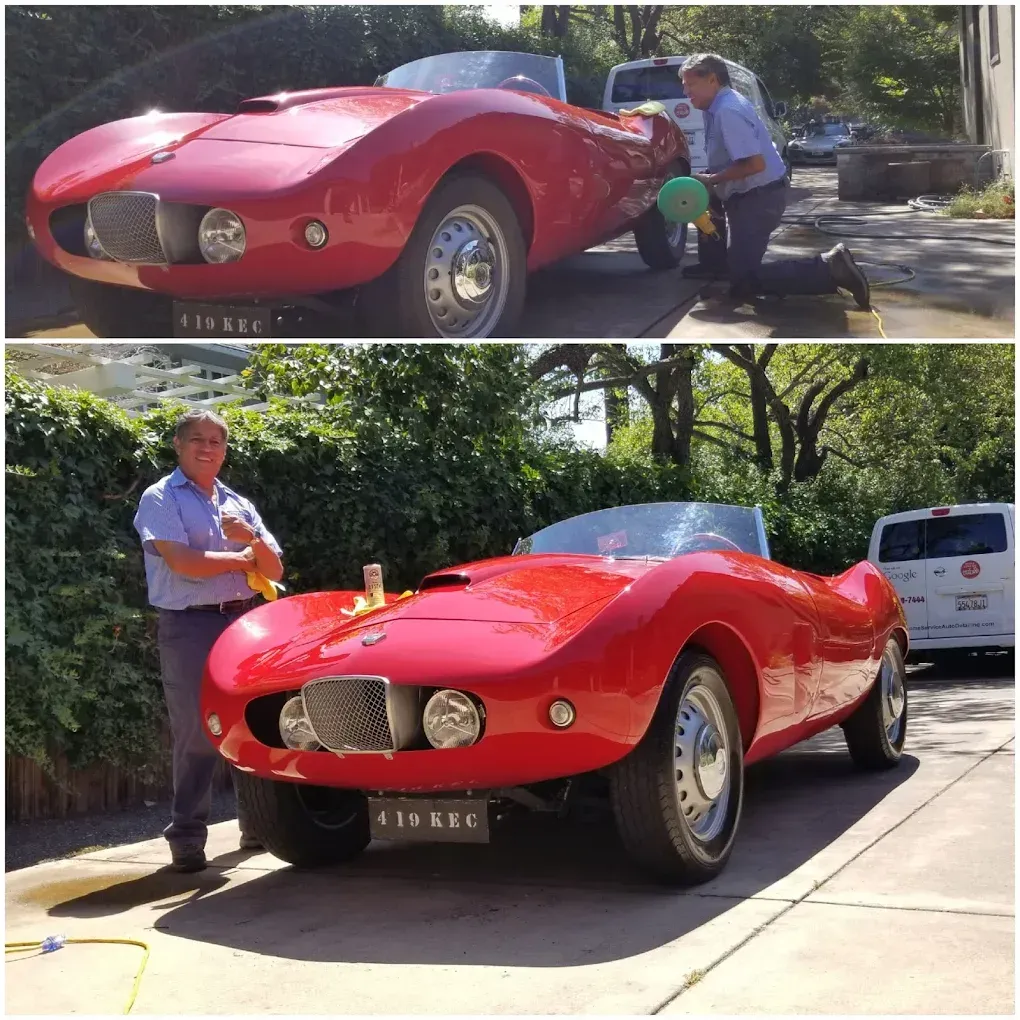 Red sports car being washed by a man in a driveway; man poses with the car after it is cleaned.