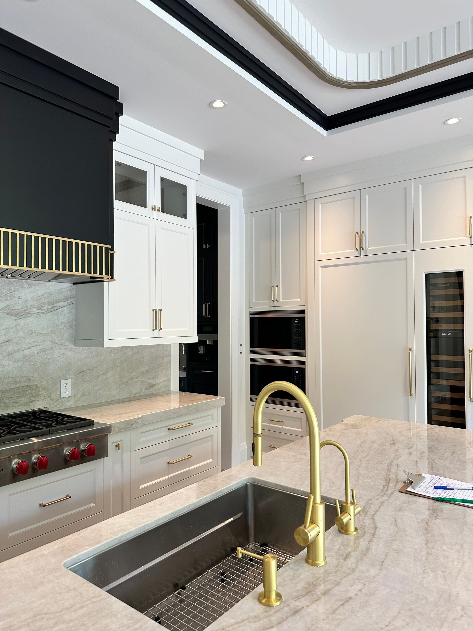 A kitchen with a sink , stove and refrigerator