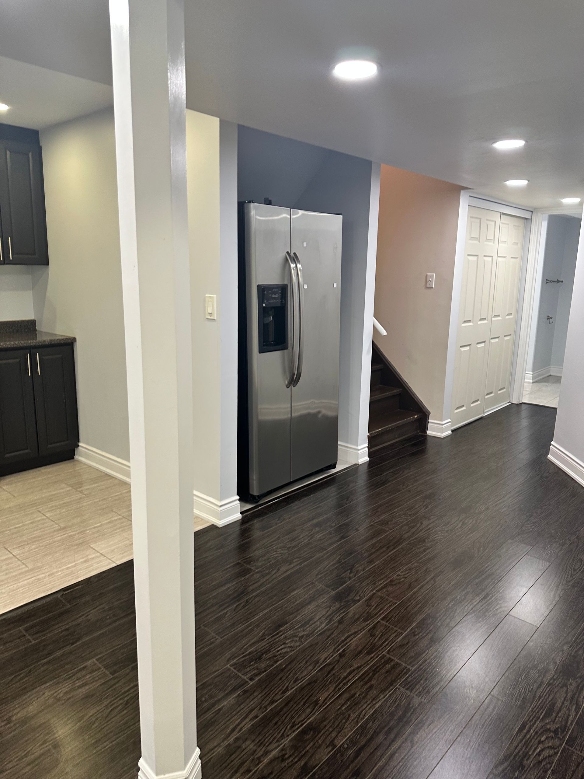 There is a refrigerator in the middle of the room.