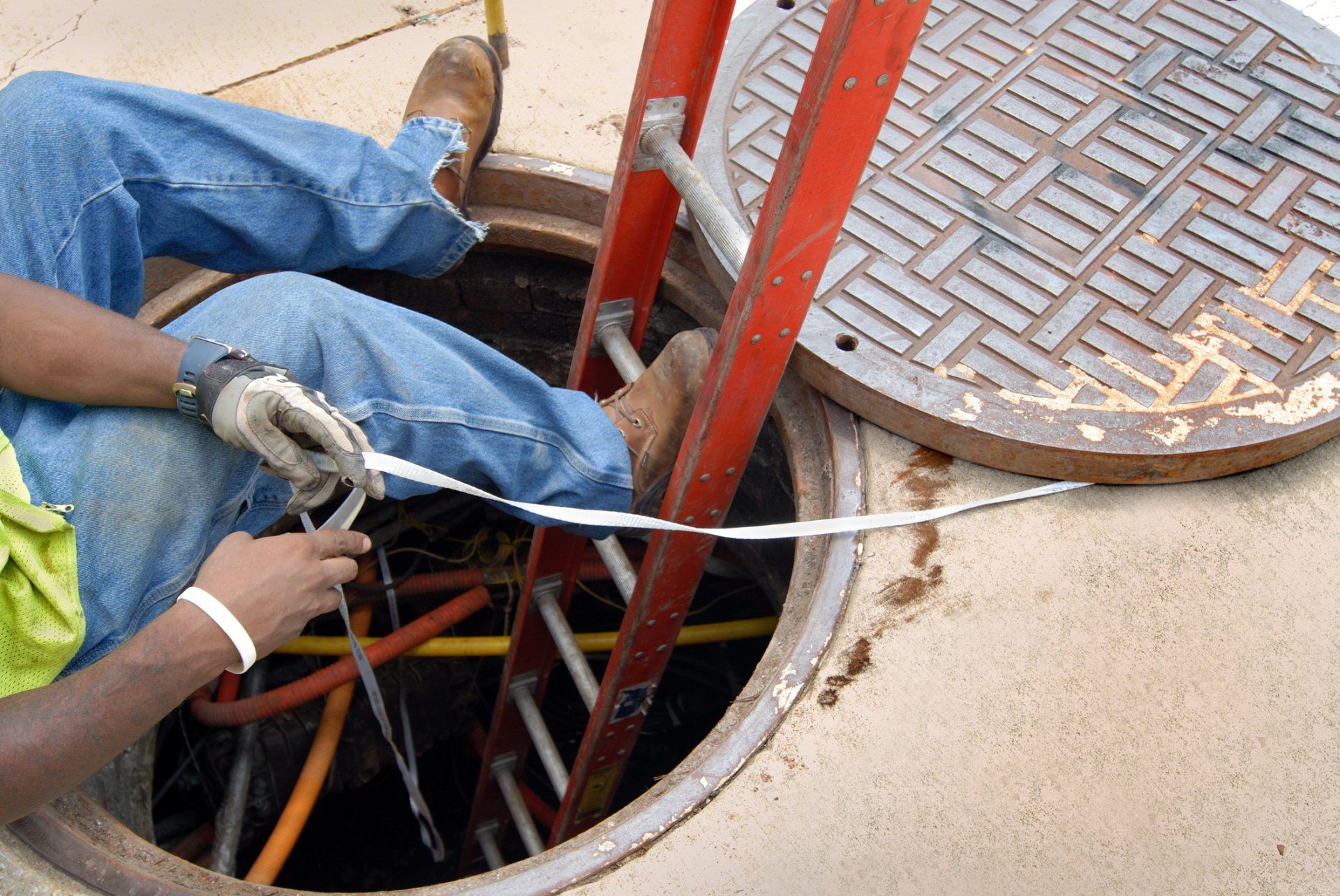 A manhole cover with a ladder attached to it