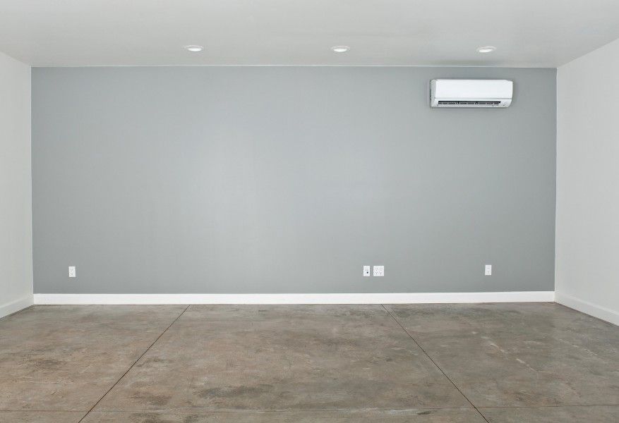 Derbyshire Specialists Group converted garage with walls painted and flooring about to be laid in Derby