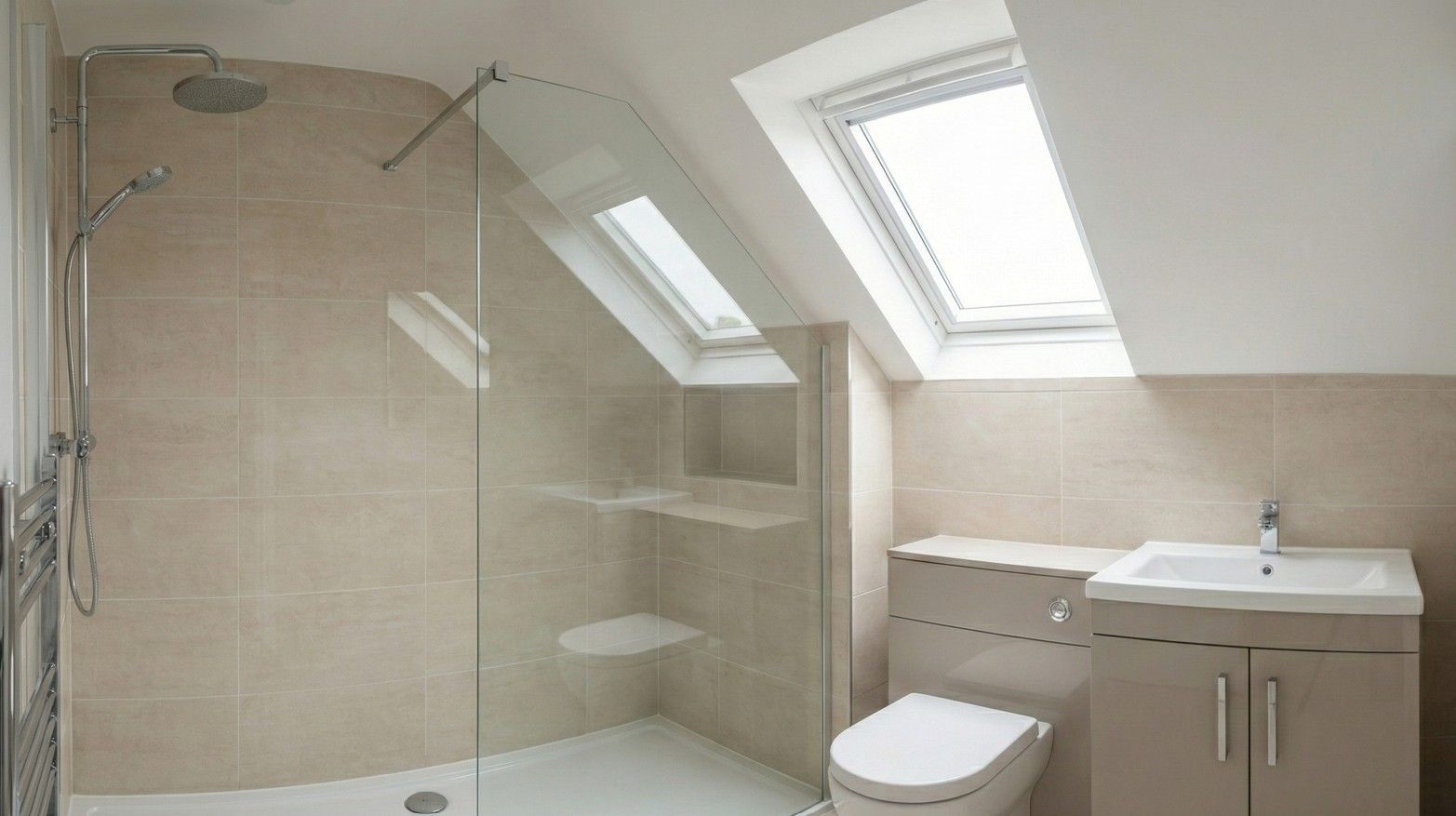 Derbyshire Specialists Group a stylish and modern en-suite bathroom within the dormer conversion, featuring a walk-in shower and a Velux window.