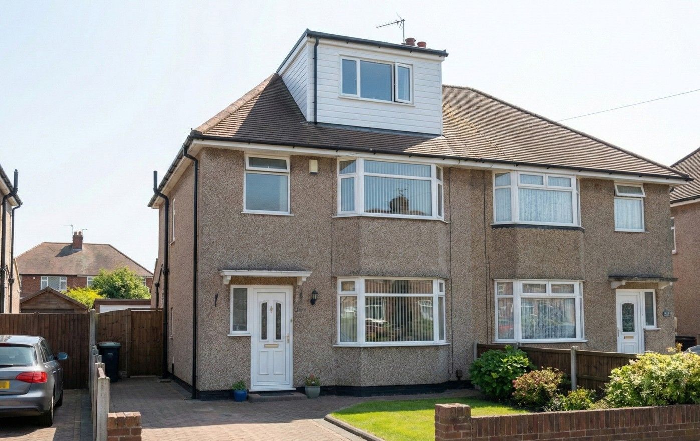 Derbyshire Specialist Group front exterior view of a semi-detached house, with a finished white dormer conversion visible on the hip roof.
