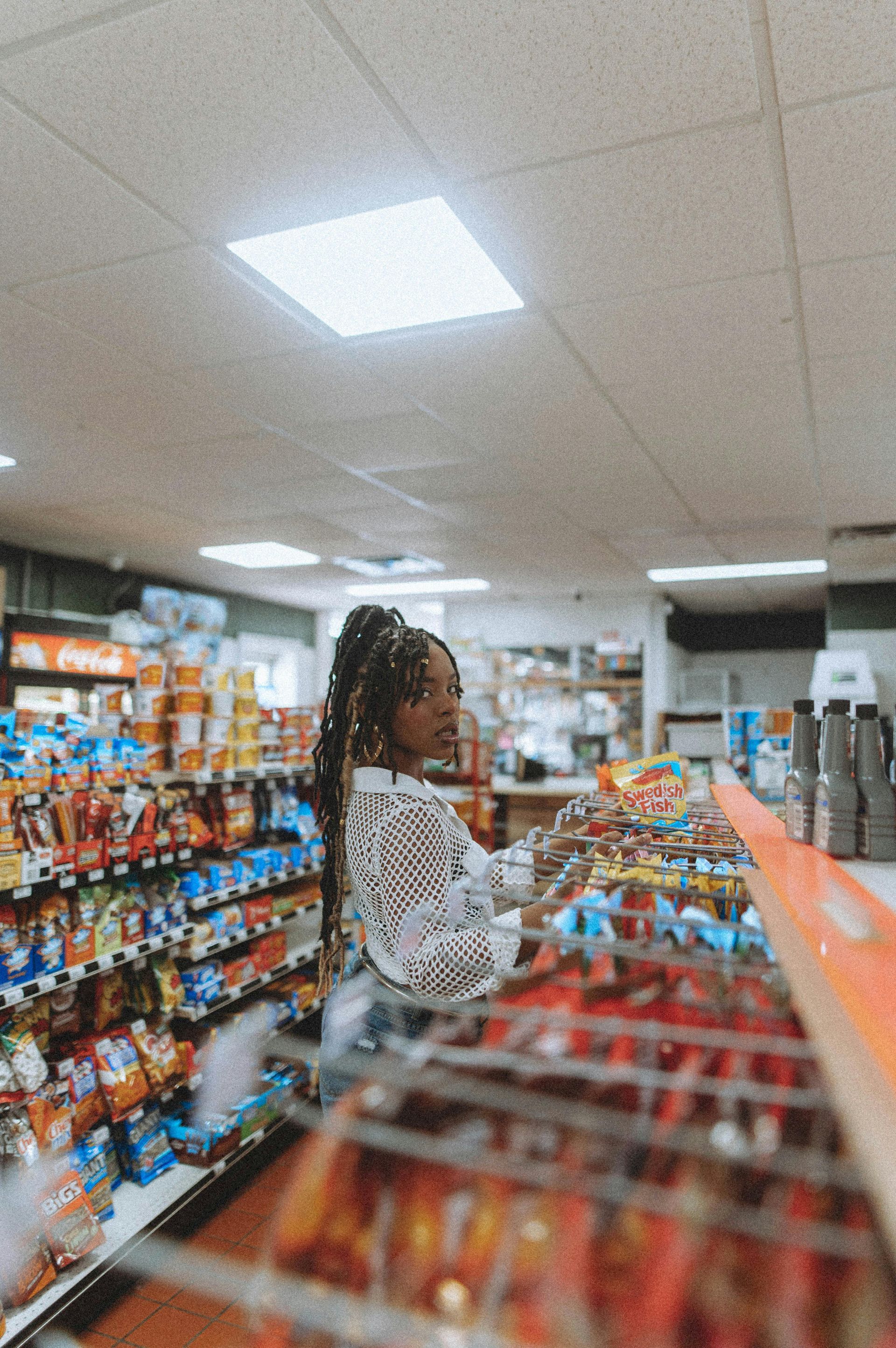 A woman is shopping in a grocery store.