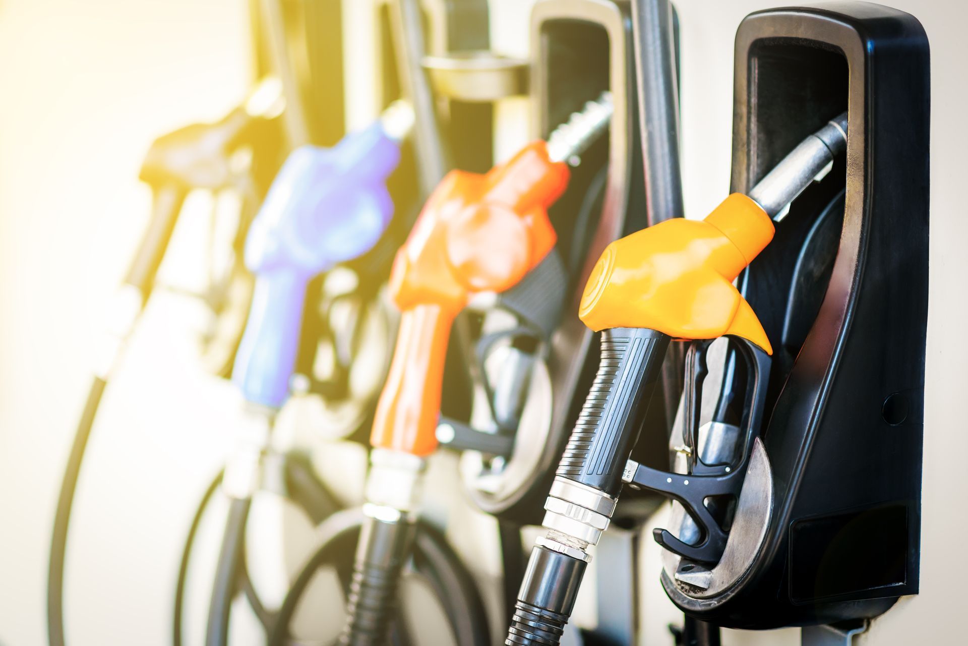 A row of gas pumps are lined up in a gas station.