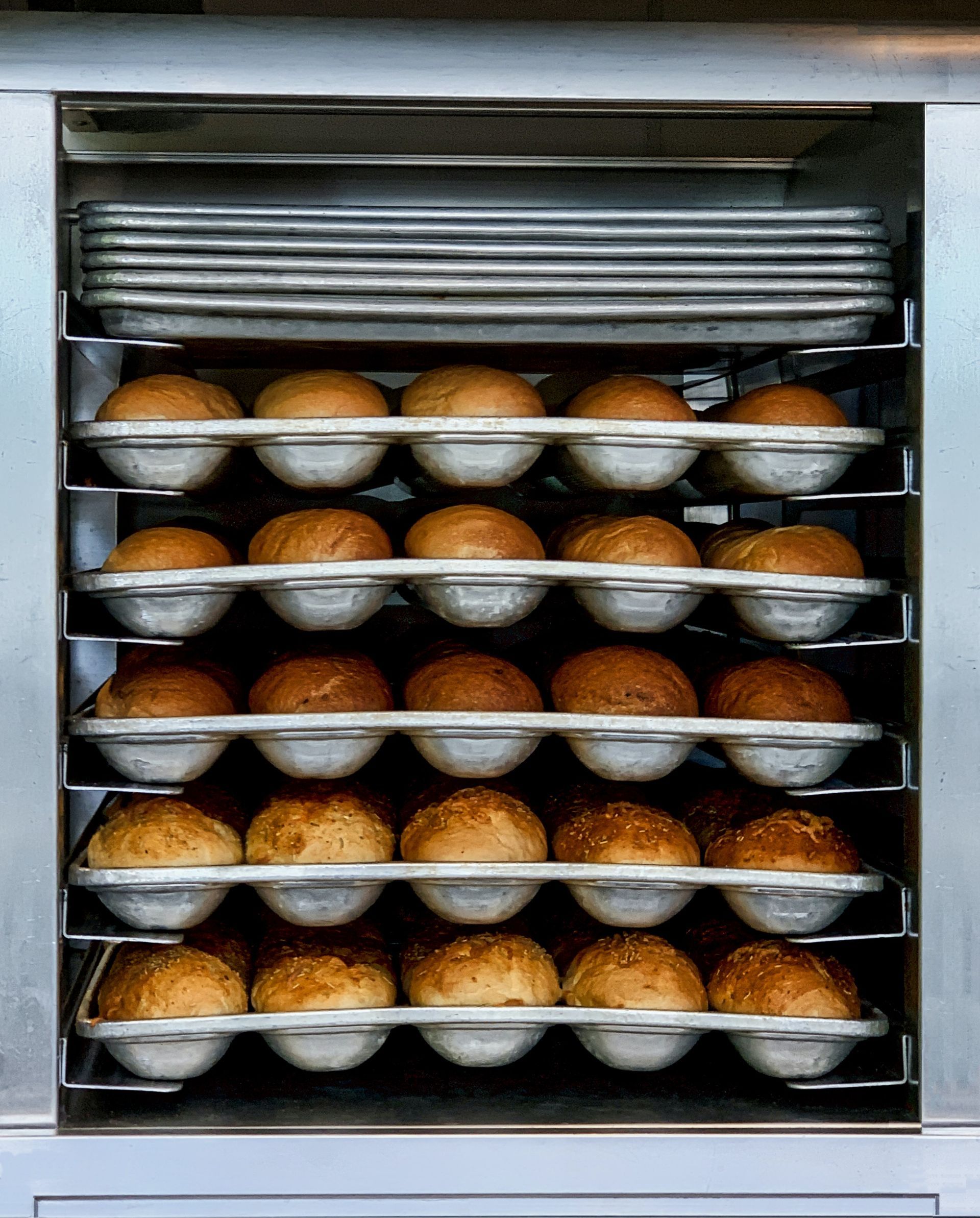 An assortment of freshly baked goods displayed in a commercial oven.