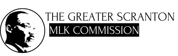 Logo of The Greater Scranton MLK Commission, with a circular portrait of Martin Luther King Jr. and text.