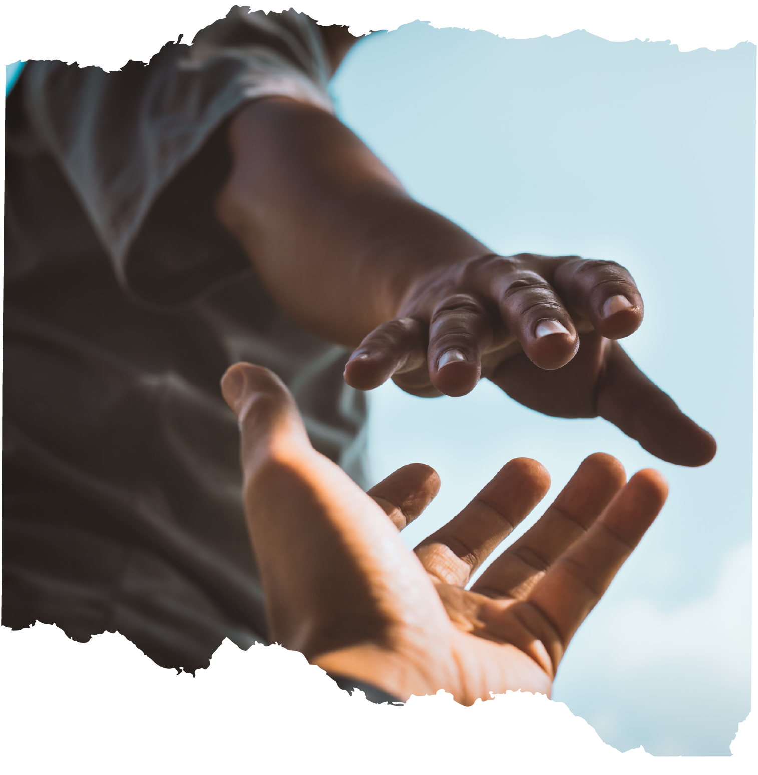 Two hands reaching toward each other under a blue sky, palms up and down.