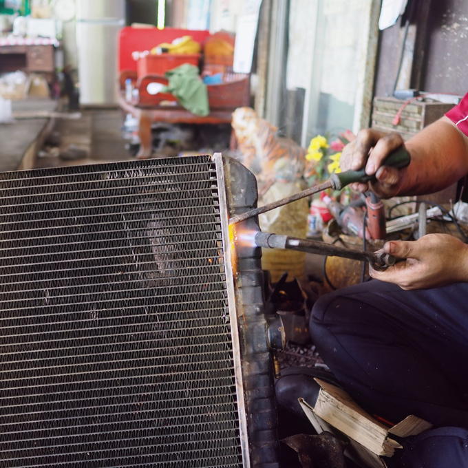 Radiator Shop Near Me — Mechanic Holding A Radiator In Forney, TX