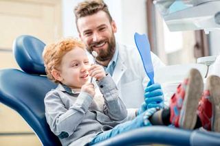 Teeth Whitening — Friendly Dental Staff Having Fun with a Child Patient in Whiting, IN