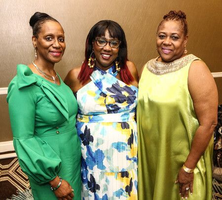 Three women having their picture taken at an event at Overflow Christian Center