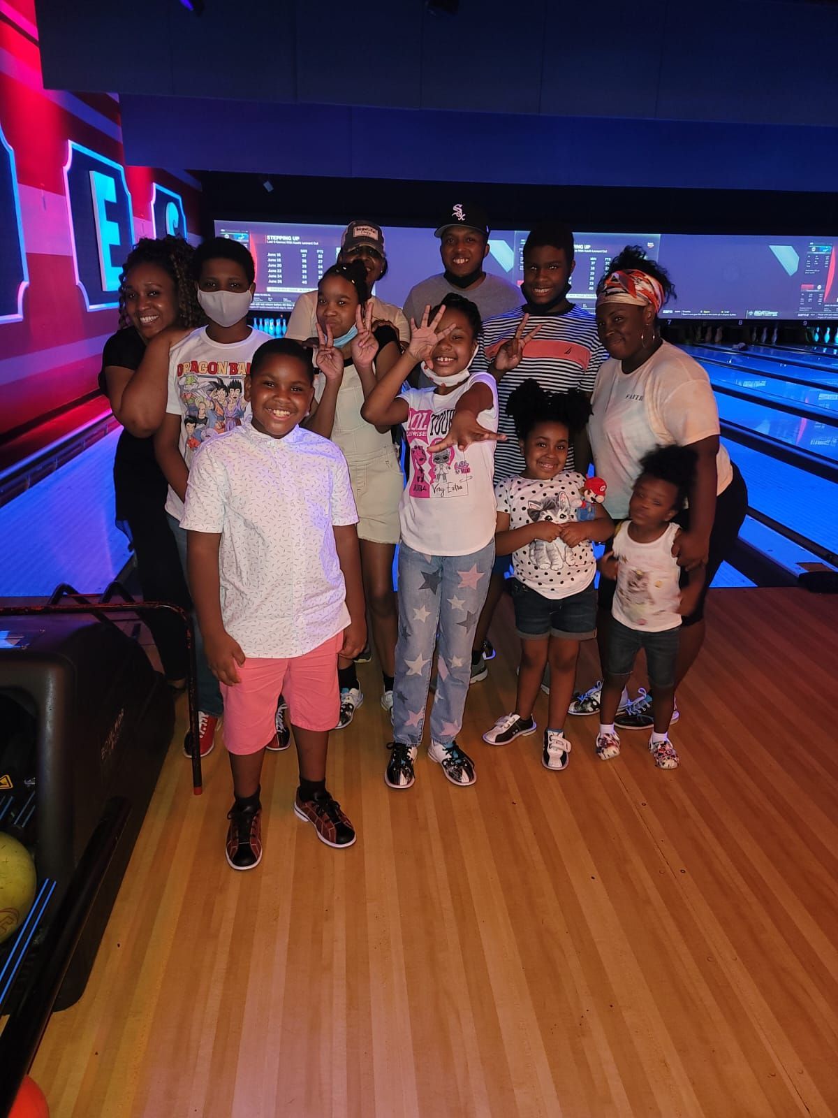 Some kid church members with adults at a Bowling Center
