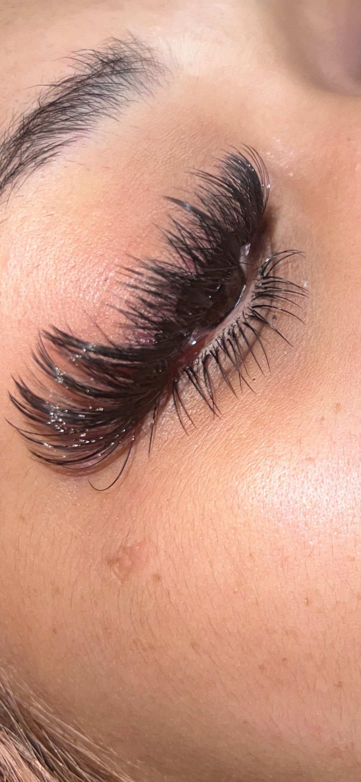 A close up of a woman 's eye with long eyelashes and mascara.