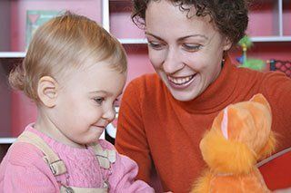 Woman with baby, after school program Fayetteville, NC