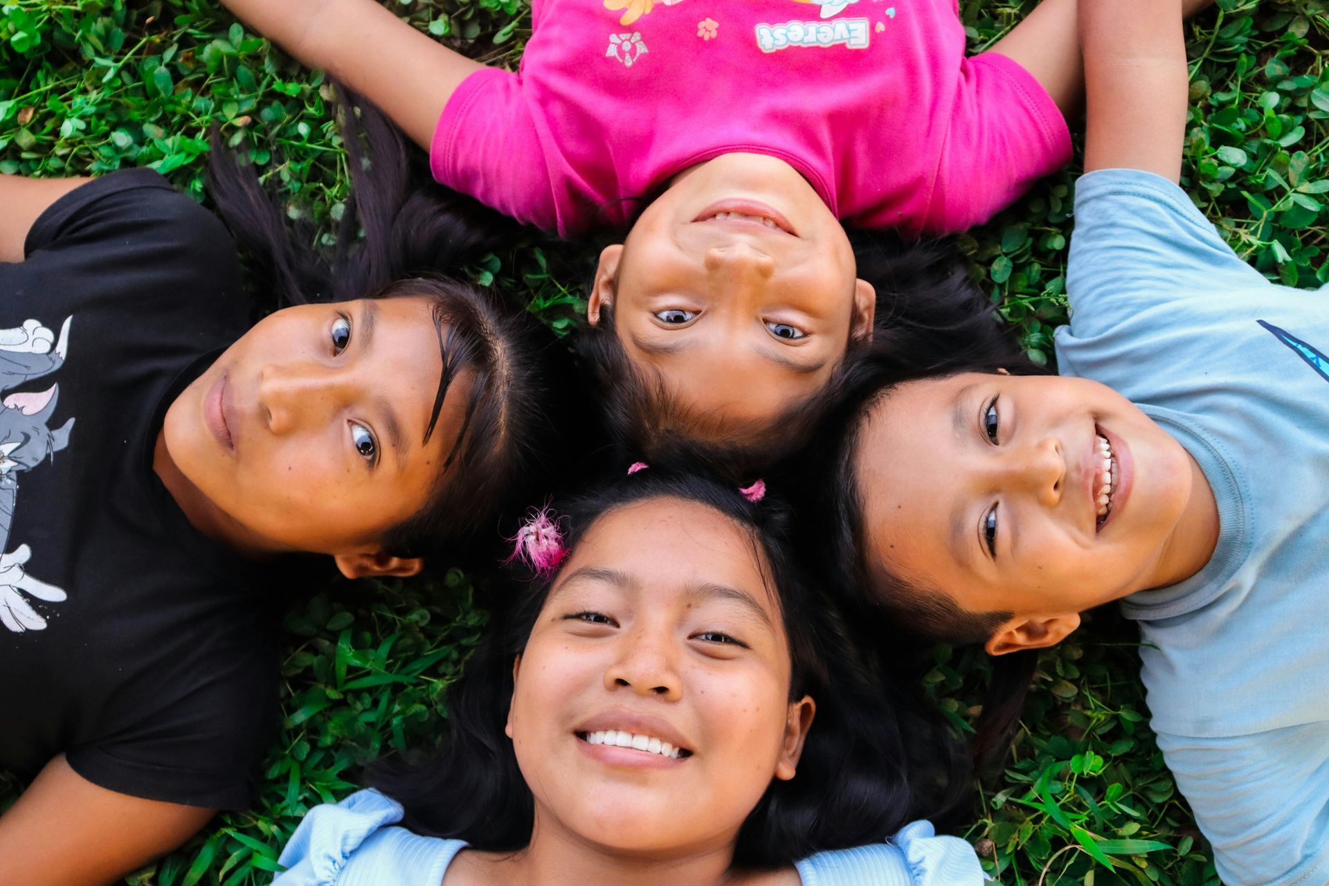 Happy Children Laying in Grass in Fayetteville, NC