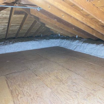 There is a lot of insulation in the attic of a house.