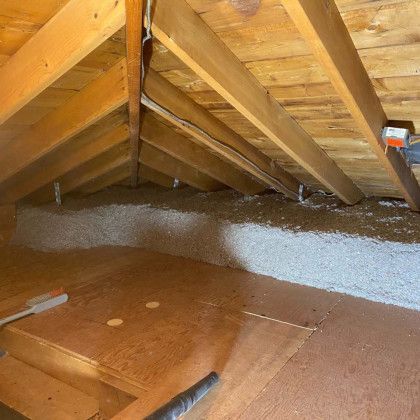 There is a lot of insulation in the attic of a house.
