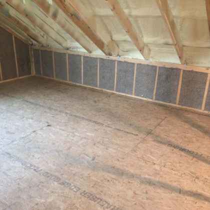 A room with a wooden ceiling and a wooden floor.