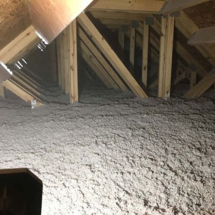 There is a lot of insulation in the attic of a house.