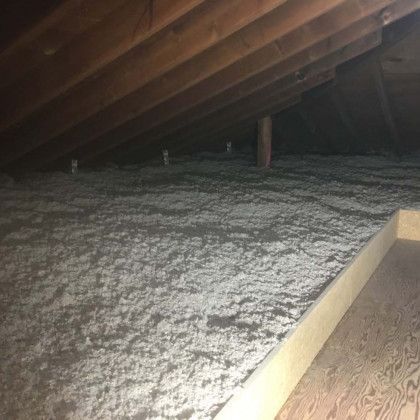 There is a lot of insulation in the attic of a house.