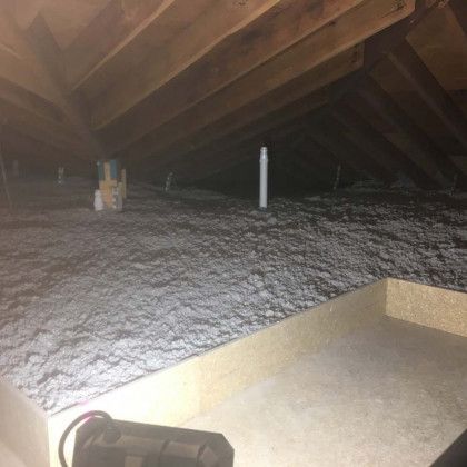 There is a lot of insulation in the attic of a house.