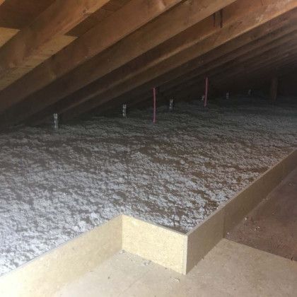 There is a lot of insulation in the attic of a house.