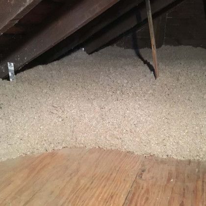 There is a lot of insulation in the attic of a house.