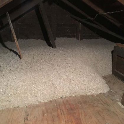 There is a lot of insulation in the attic of a house.