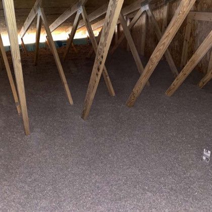 There is a lot of insulation in the attic of a house.