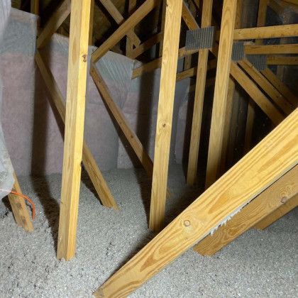 A room with a lot of wooden beams and a lot of insulation.