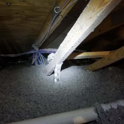 There is a lot of insulation in the attic of a house.
