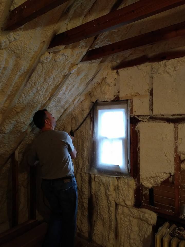 A man is standing in a room with a window.
