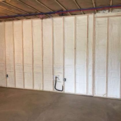 A room with a wall covered in white spray foam.