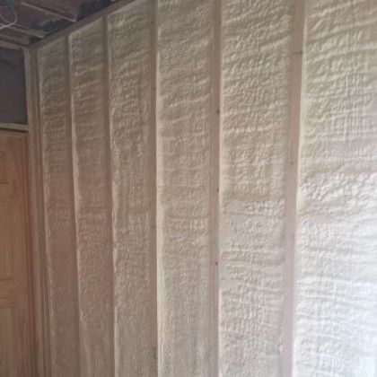 A room with a wall covered in white spray foam.