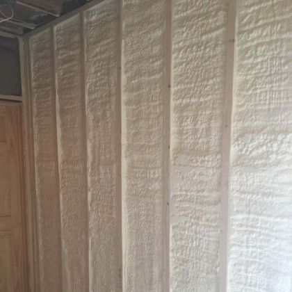 A room with a wall covered in white spray foam.