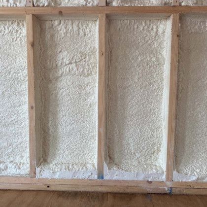 A wall with a lot of foam on it and a wooden frame.