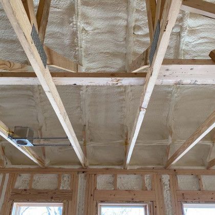 The ceiling of a house is covered in spray foam.