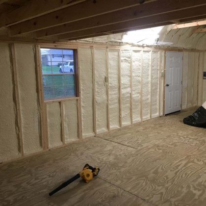 A room with a lot of insulation on the walls and a window.