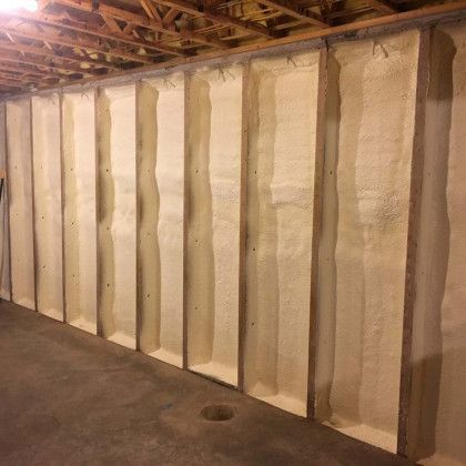 A wall in a basement with a lot of foam on it.