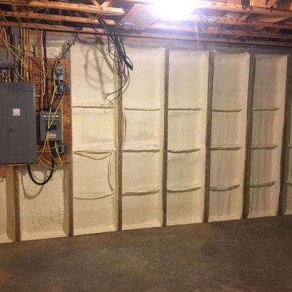 A basement with a lot of insulation on the walls.