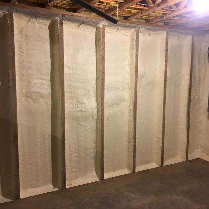 A wall with a lot of foam on it in a basement.