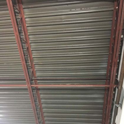 A close up of a metal roof with a red frame.
