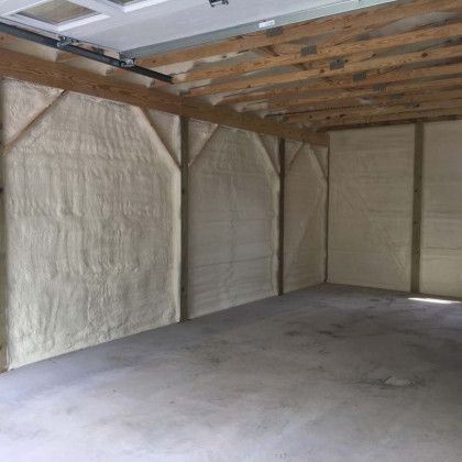 A garage with a lot of insulation on the walls and ceiling.