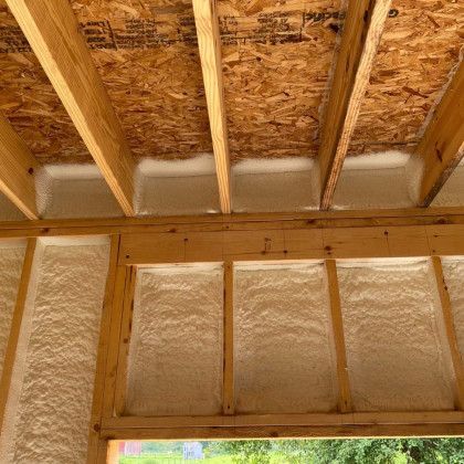 The ceiling of a house is insulated with spray foam.