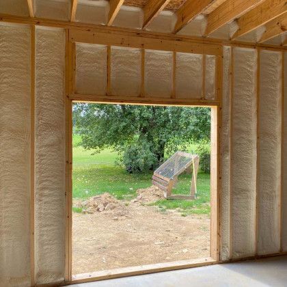 A room with a large window and a tree in the background.