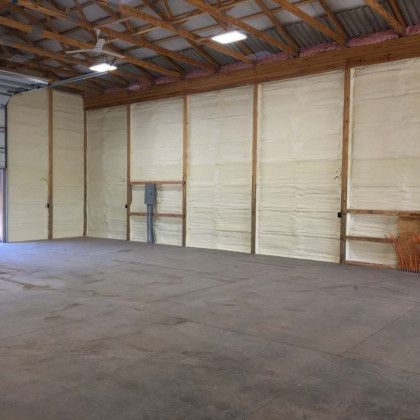 An empty warehouse with a lot of insulation on the walls and ceiling.