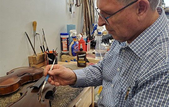 Man repairing viola — String replacements in Ogden, UT