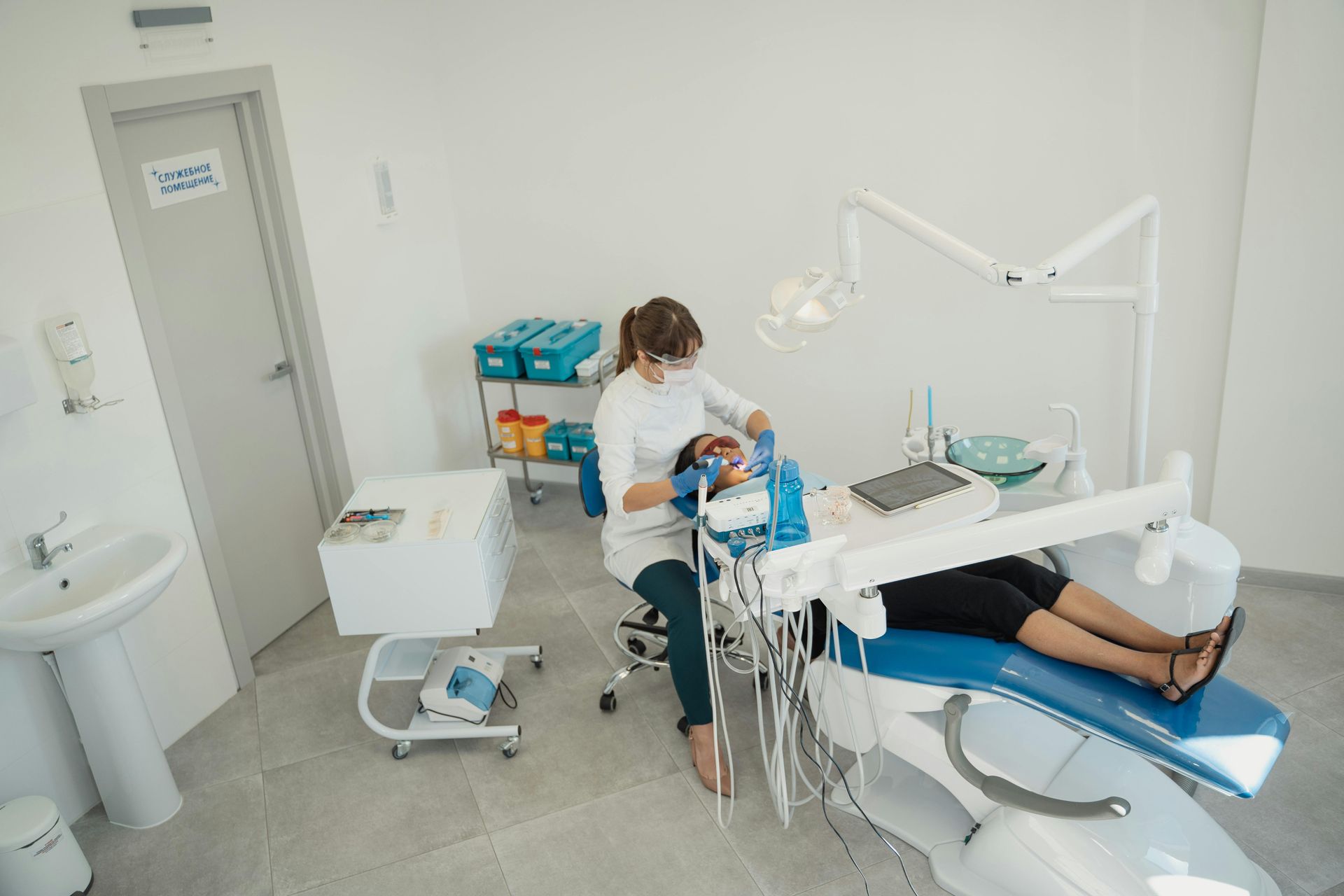 Dentist examining a patient's mouth in a dental office.