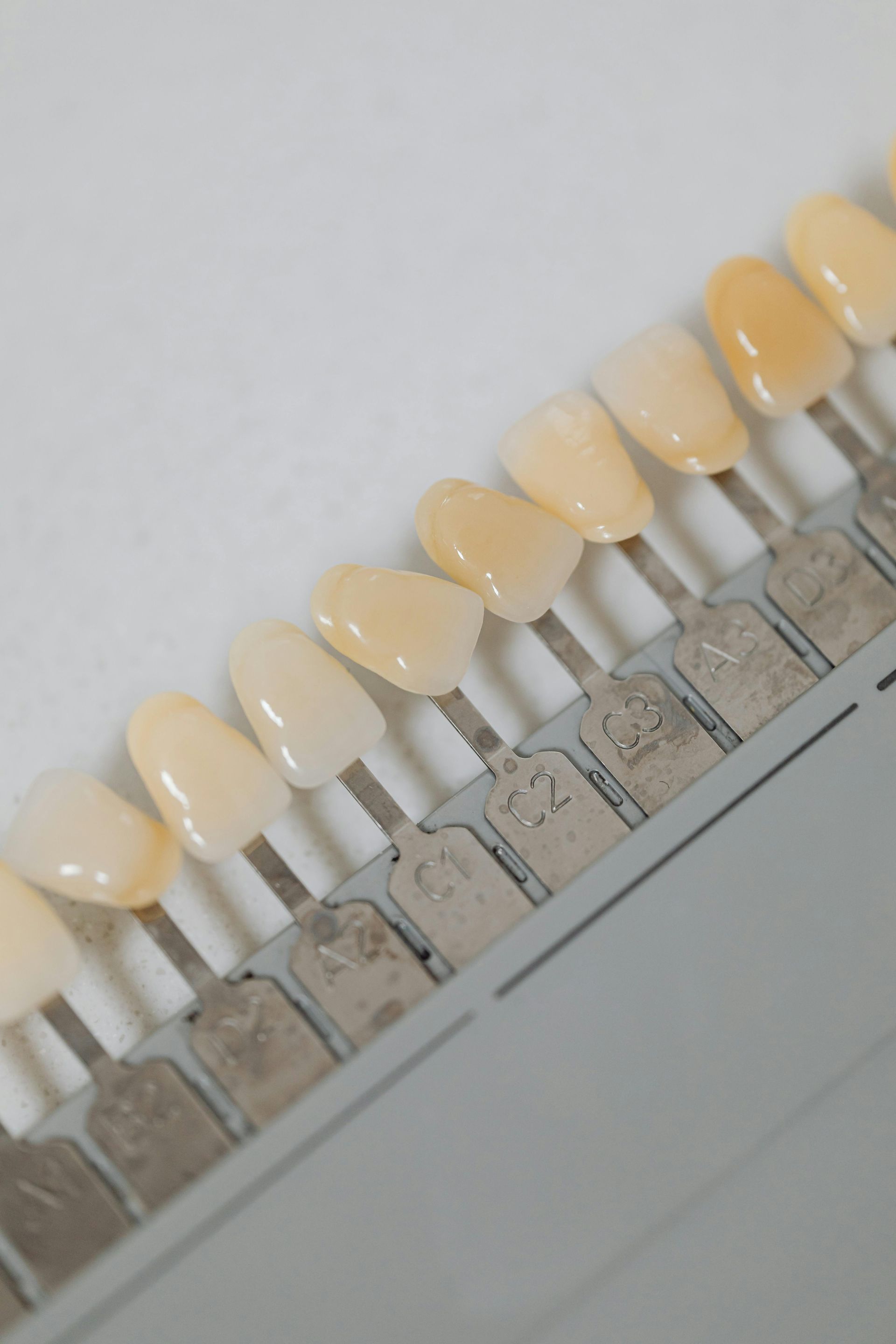 Tooth shade guide with various shades of white and yellow.